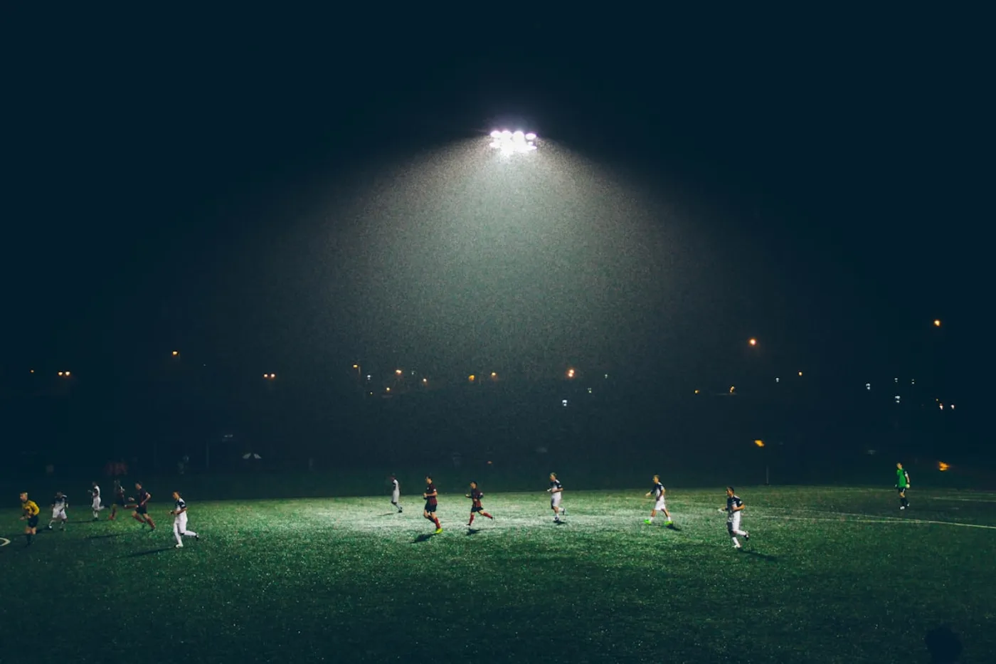 Stadium crowd under lights representing live sports data markets